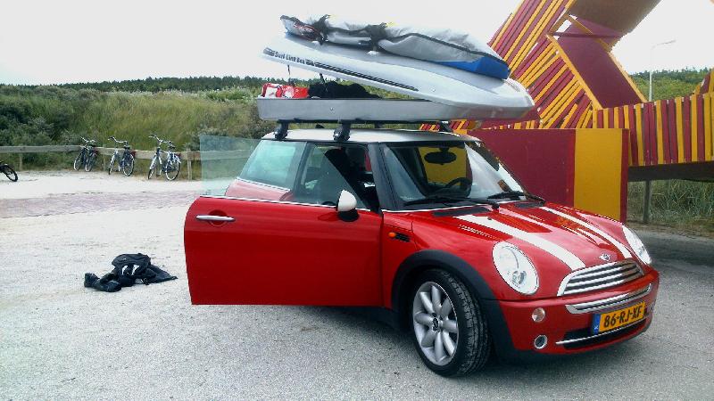 A Mini Cooper with a Surfboard Rack